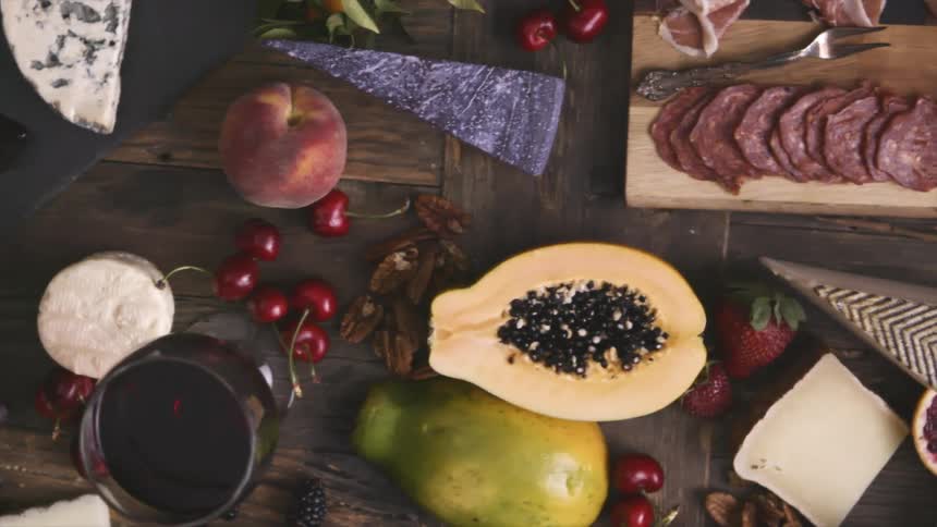 A spread of meats cheeses and fruit