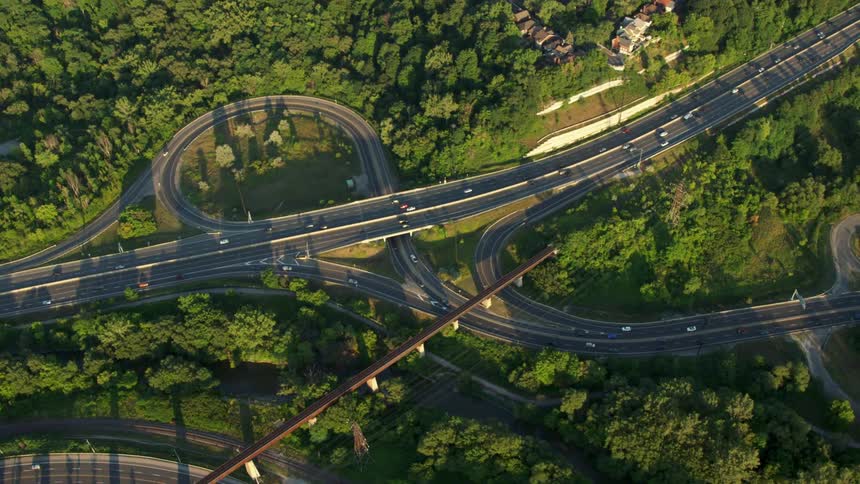 Aerial footage of traffic flowing on a highway intersection