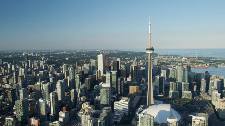 Aerial of a city scape featuring downtown Toronto's CN Tower and Roger's Center Stadium