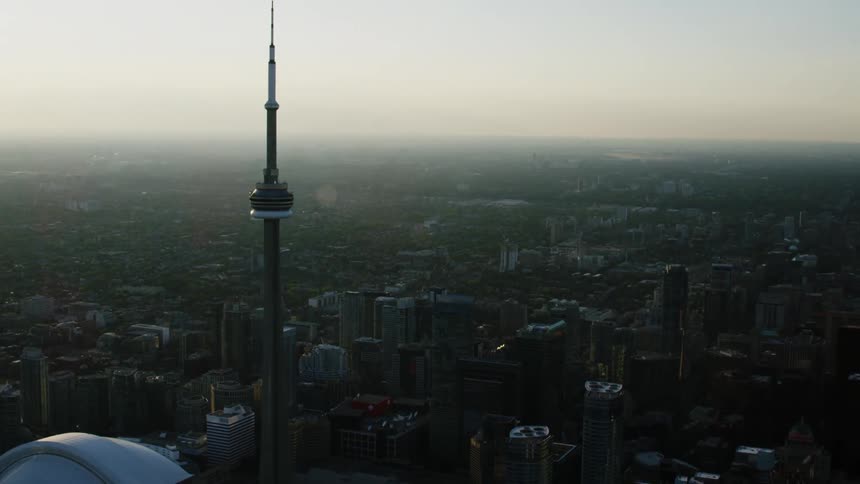 Aerial of a city scape featuring downtown Toronto's CN Tower and Roger's Center Stadium