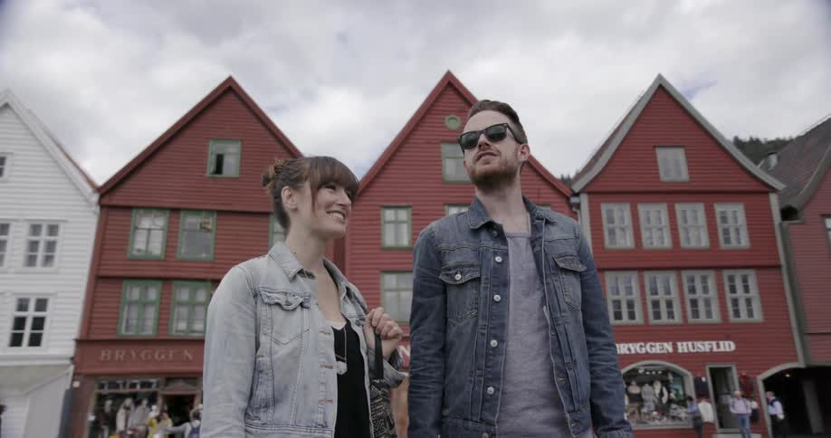 A man and women talking and standing outside on a cloudy day