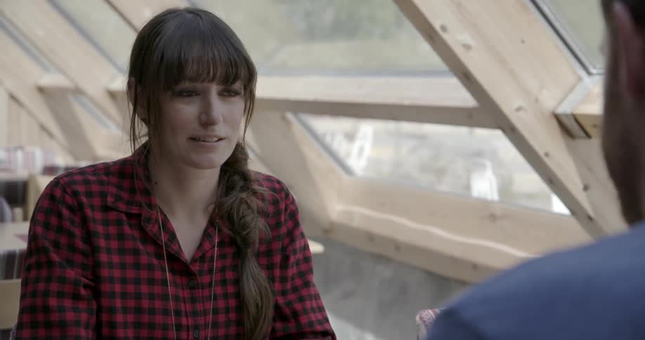 A woman is nodding her head as a man talks to her