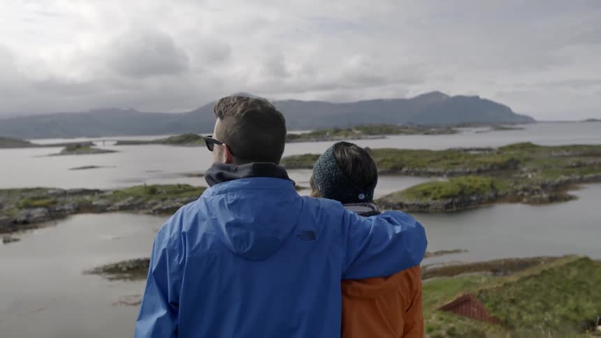 A man and woman view lakes and mountains