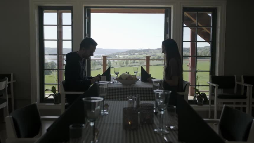 A man and woman dine in a restaurant