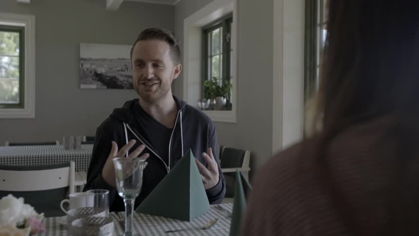 A man sits and talks with a woman