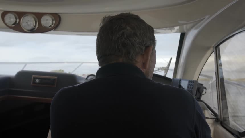 The back of a man flying in an airplane