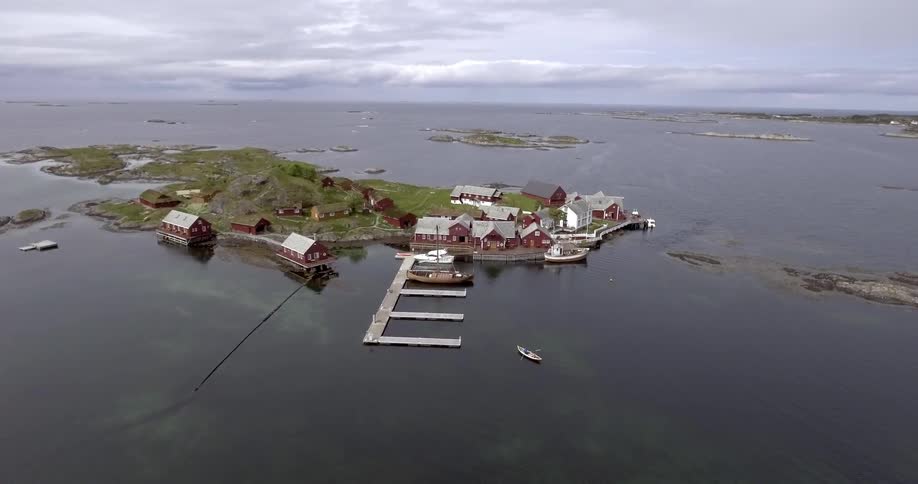 Aerial view of a small island with a dock and houses near the water