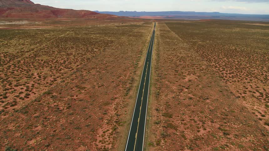 Aerial view of a road in a rural area is displayed