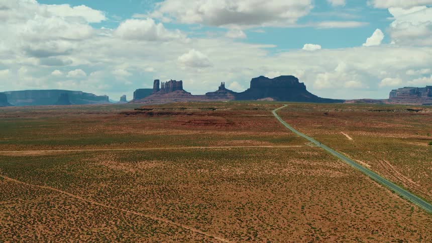 A long road through the badlands on a sunny day