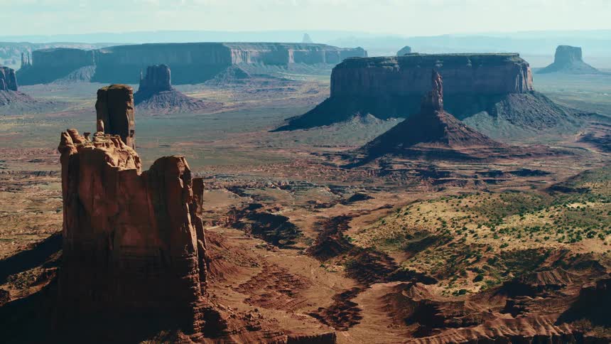 An aerial view of tall rock formations in a remote desert landscape