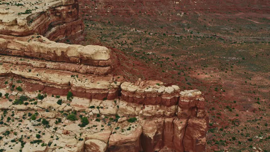 An aerial view of rocky cliffs in a desert in the daytime
