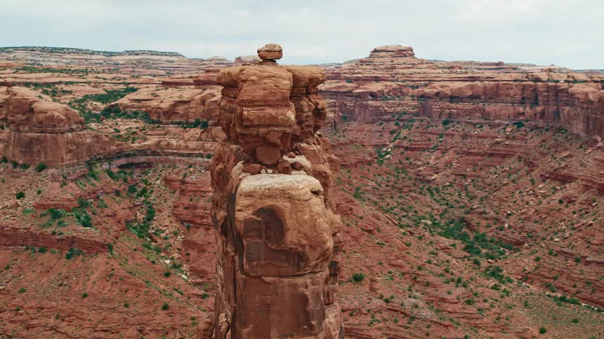 An aerial view of tall red rock formations in the wilderness