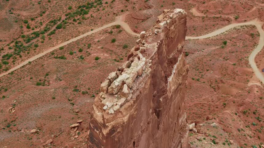 A tall narrow butte in the badlands during the day