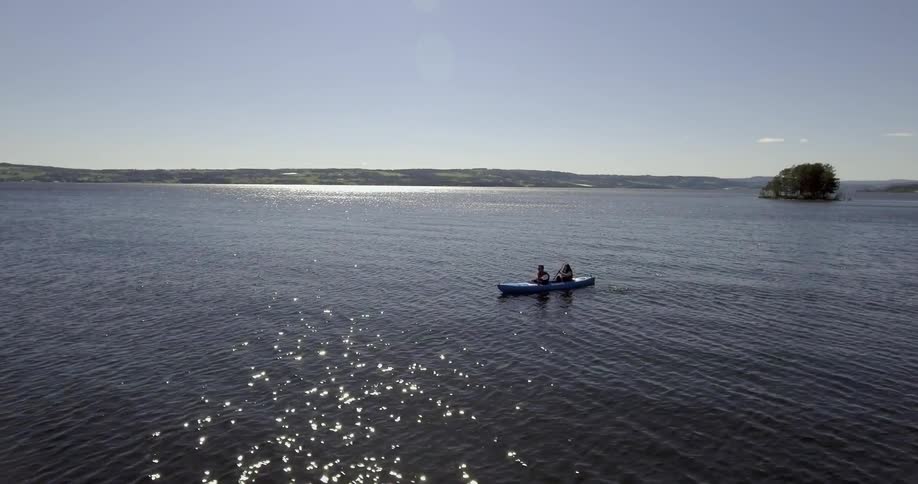 People paddling a kayak on a clear day
