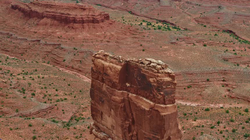 A tall narrow butte in the badlands during the day