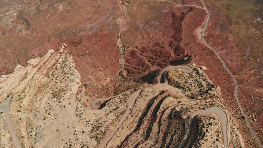 A desert with a road and a cliff