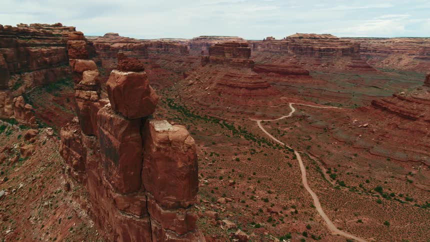 An aerial view of large red rock formations in a desert