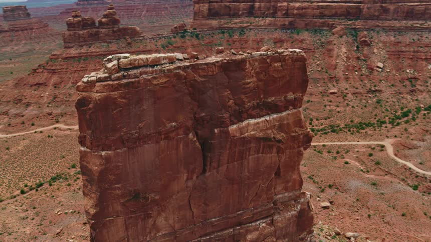 A tall rock formation is in the badlands