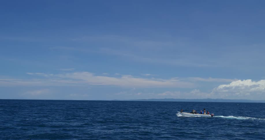 People are driving on a boat through the ocean