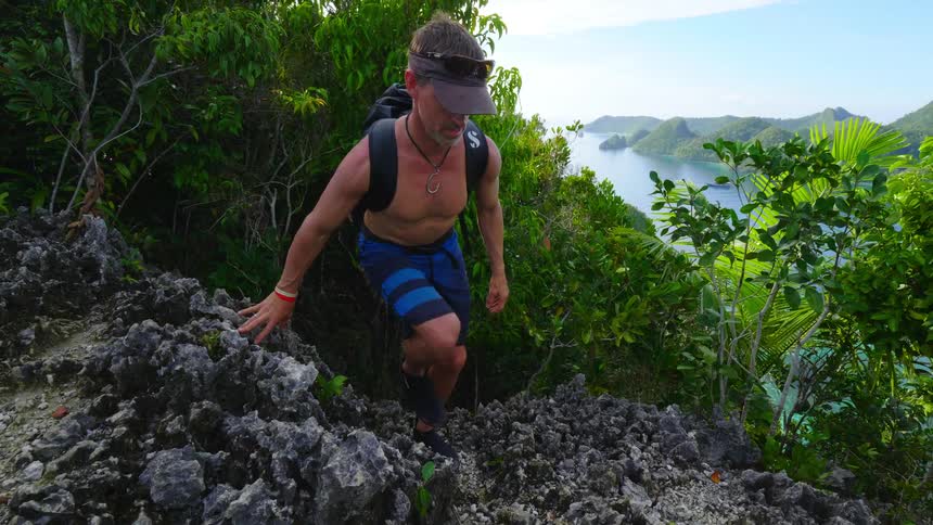 A man is hiking through the wilderness in spring