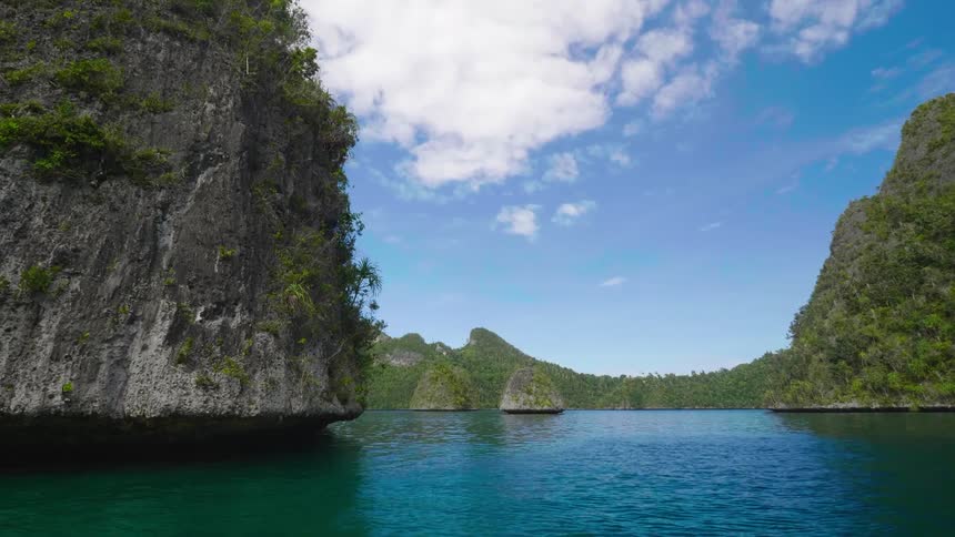 Ocean water rippling around tropical islands in the daytime