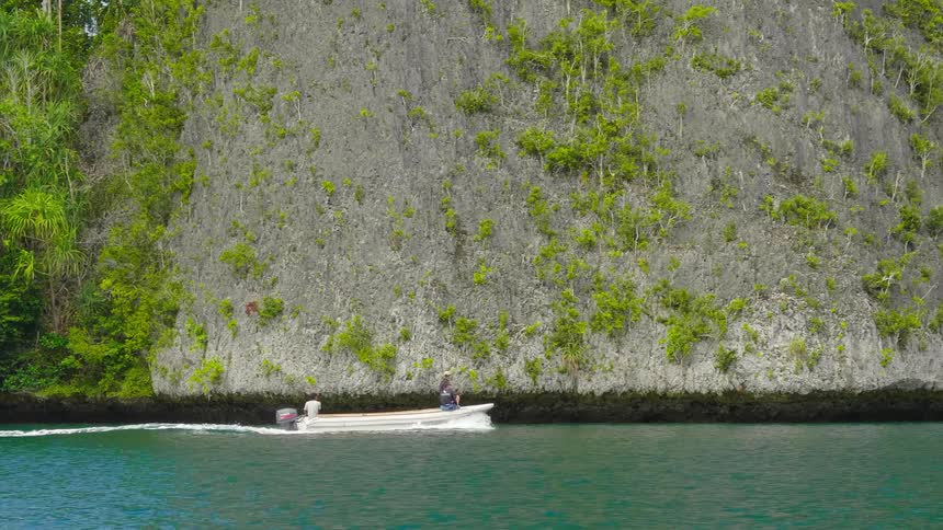 Two people are riding on a boat in the daytime