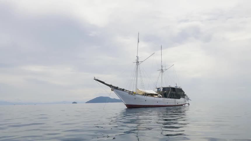 A boat is driving through the ocean