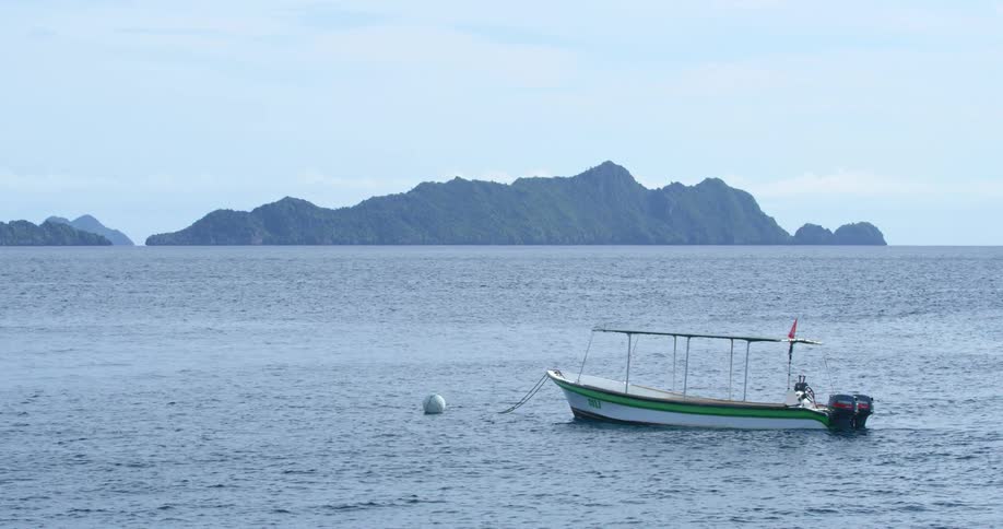 A boat is floating in the ocean water