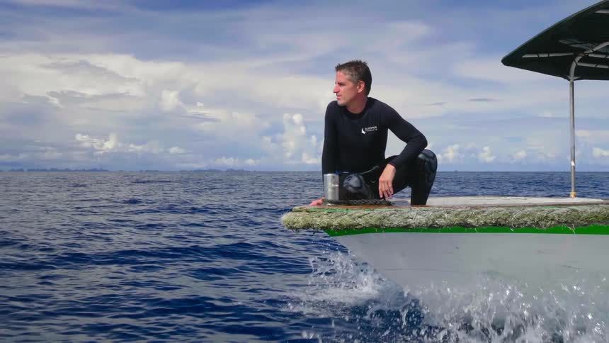 A man is riding on a boat in the ocean