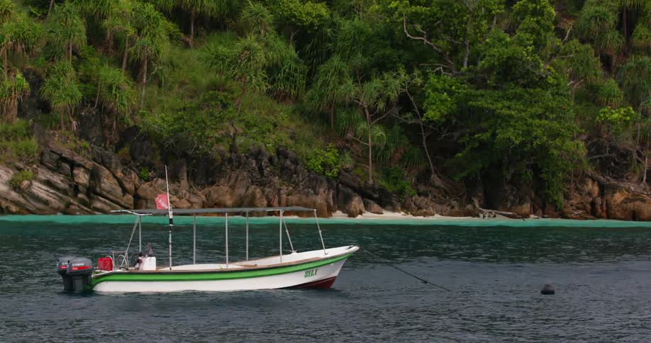 A boat tied off the shore in the water