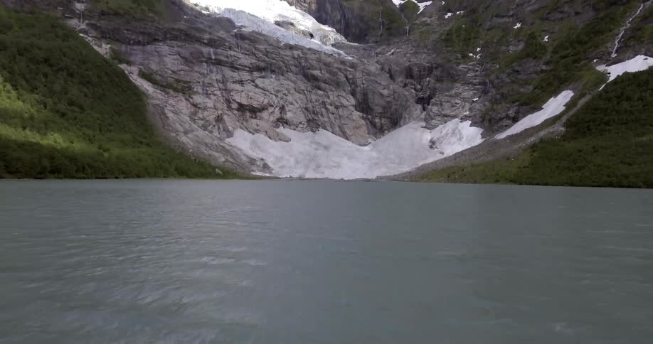 A lake sits nestled in the mountains