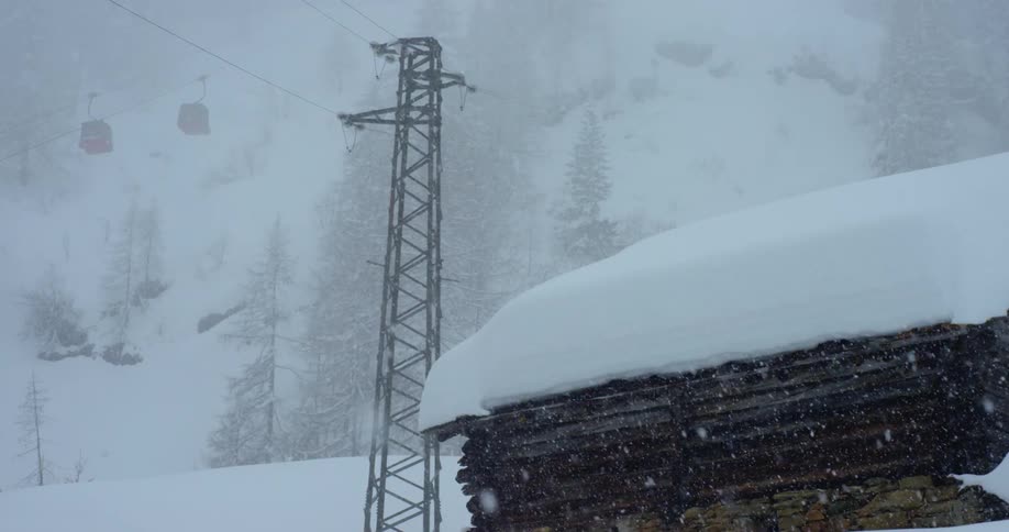 Snow falling around a cabin on a ski resort