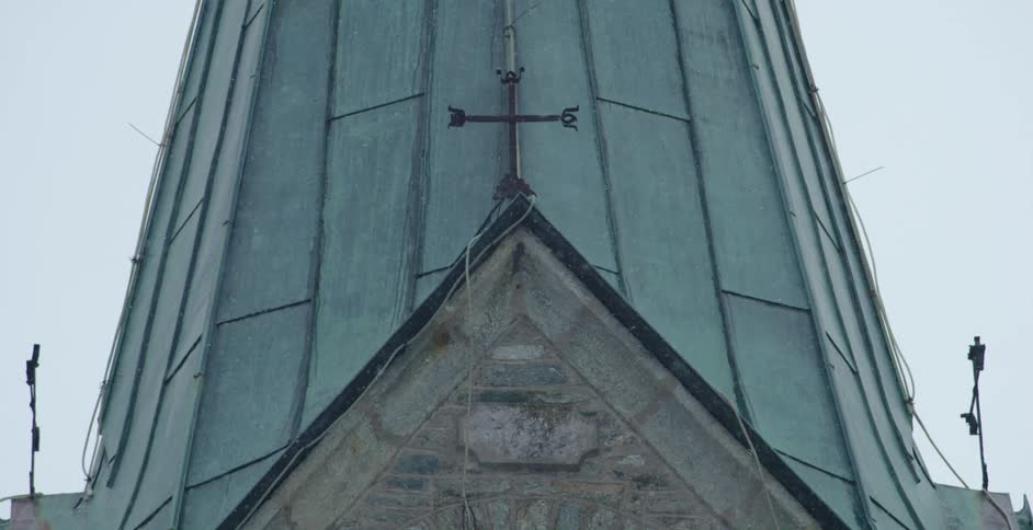 The steeple of a church on a snowy day