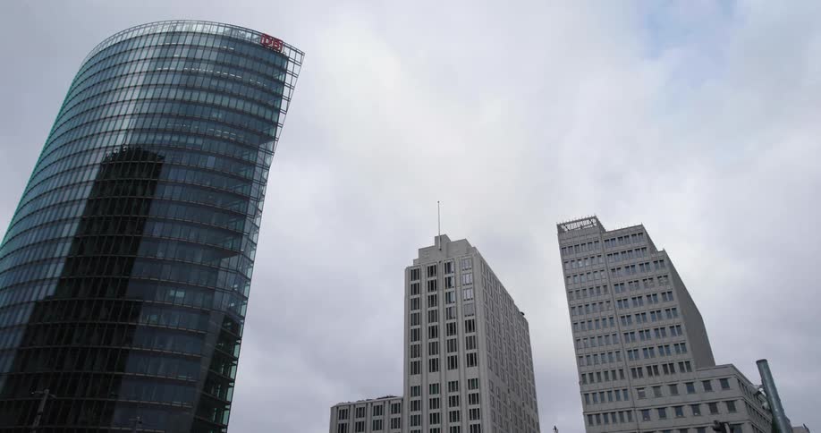Clouds floating above tall city skyscrapers in the daytime