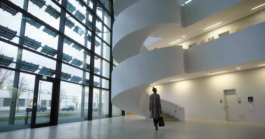 A woman is walking into a building