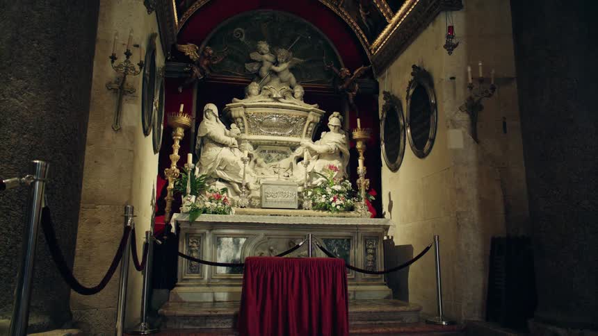 Large carved marble statue above altar in church building