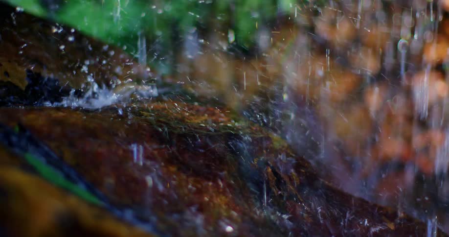 Rain falling on a rock during a storm