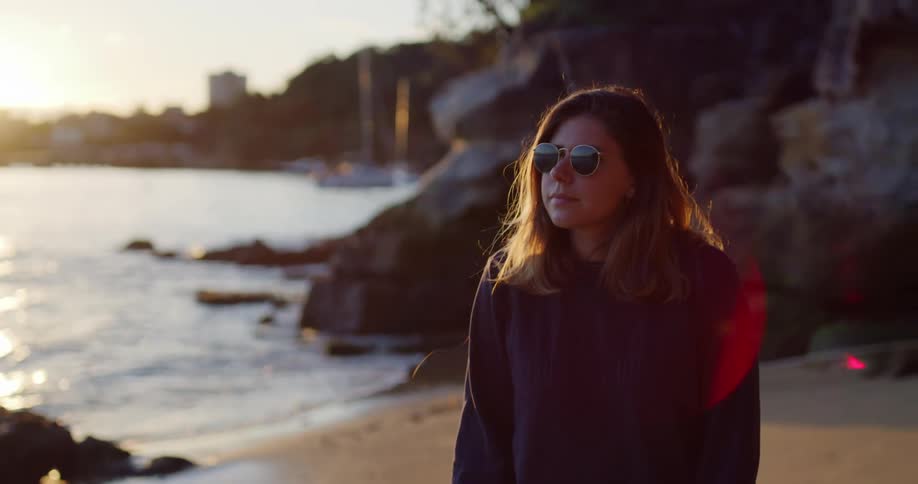 A young woman walking on the beach