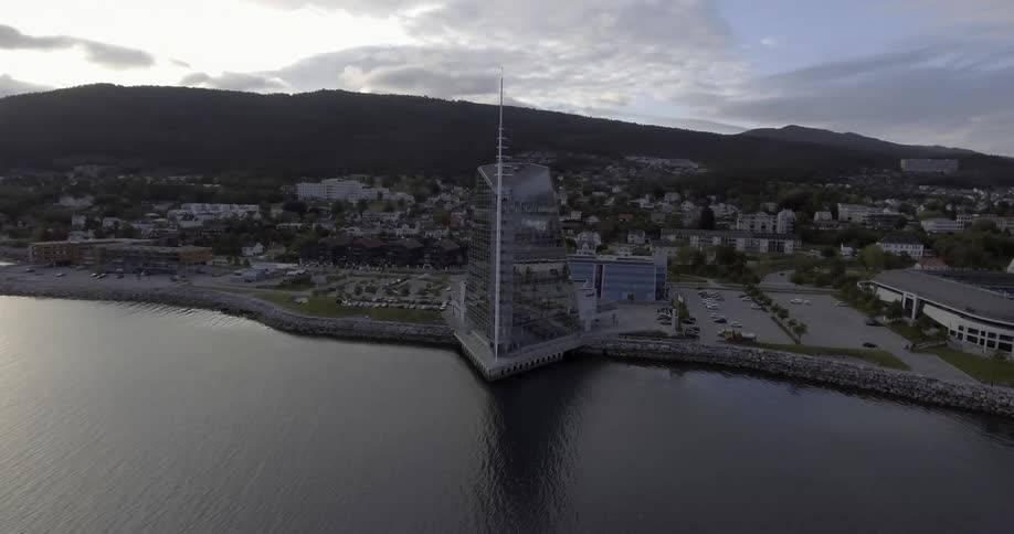 A view from the air of a glass building on a waterfront