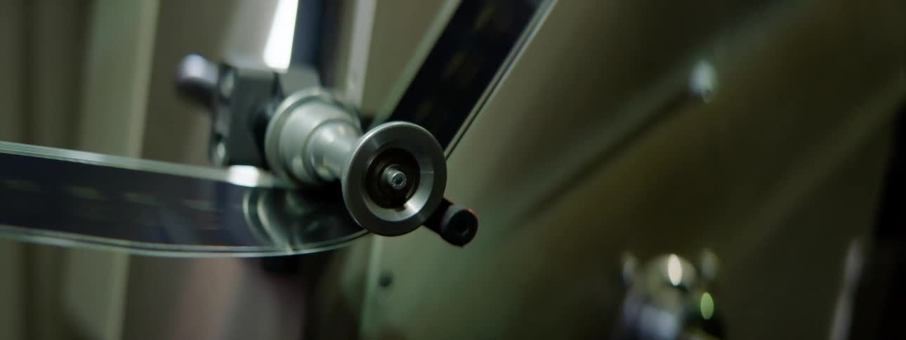 A strip of film moving through a film projector