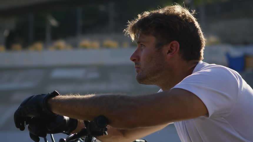 A man is sitting on a motorcycle outdoors
