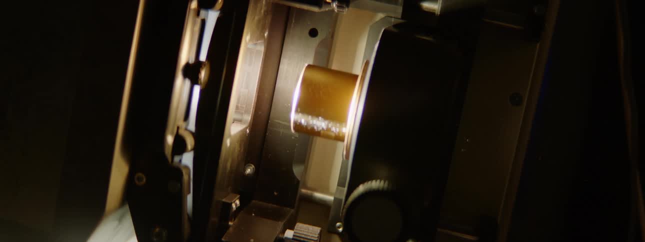 A film projector with dials projecting in the dark