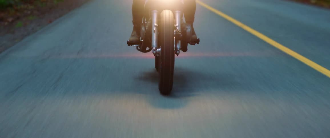 A man is riding a motorcycle in spring