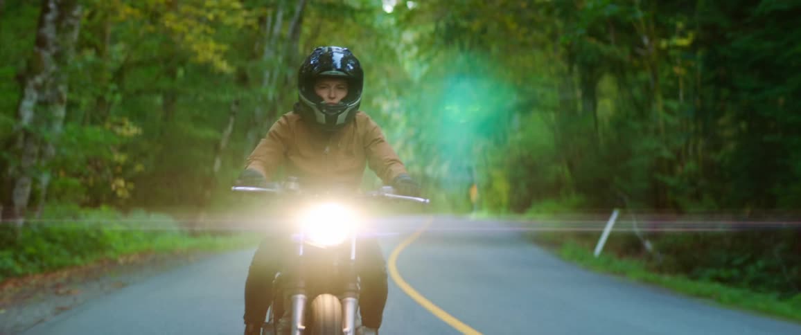A man is riding a motorcycle in spring