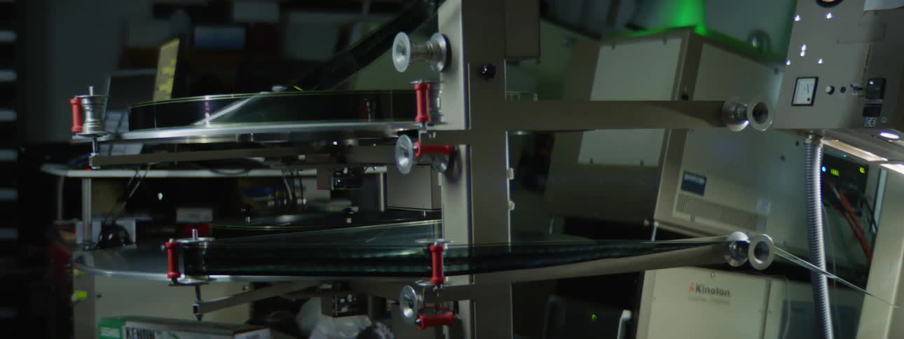 A film reel spinning on a machine indoors