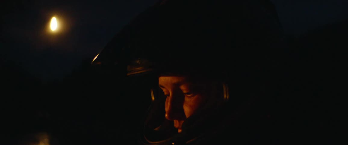 A person with a helmet with trees and the sky in the background