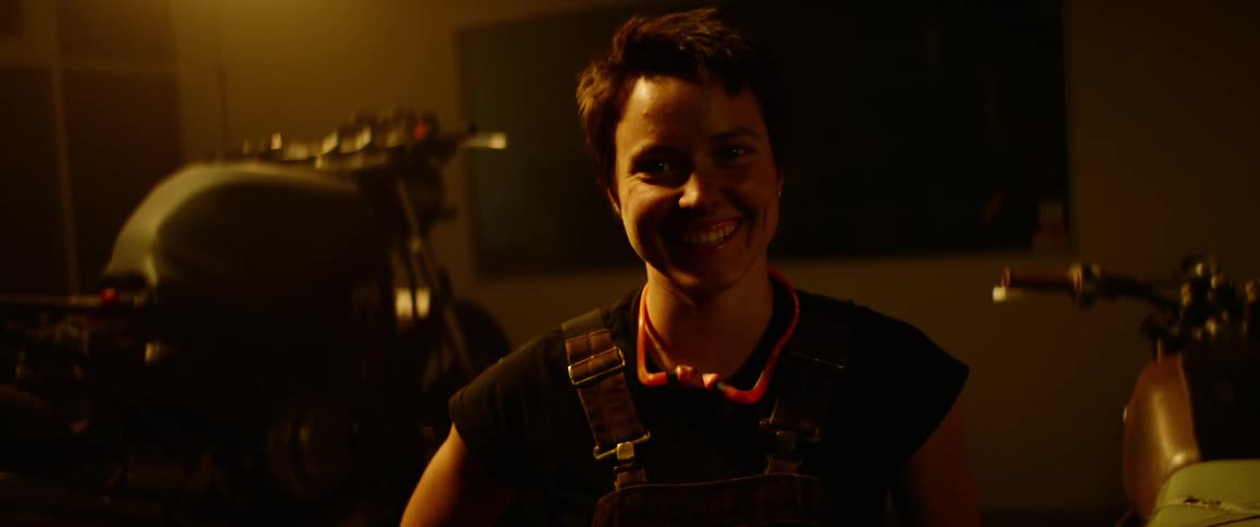A woman is standing in a room and smiling