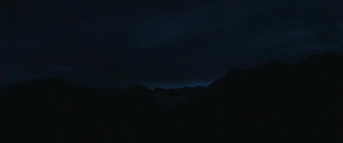 Heavy rain falls on a beach at night