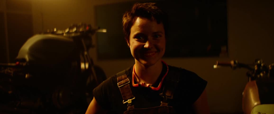 A woman is standing indoors at night