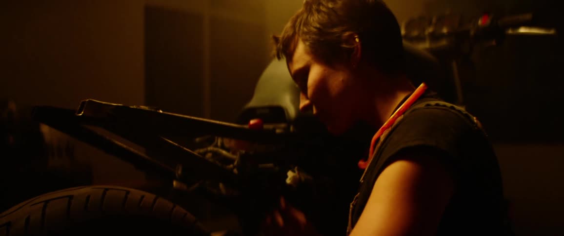 A mechanic working on a motorcycle
